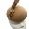 Tan felt headpiece with 2 large brown feathers with some coloured pearl detail to the base of feathers.